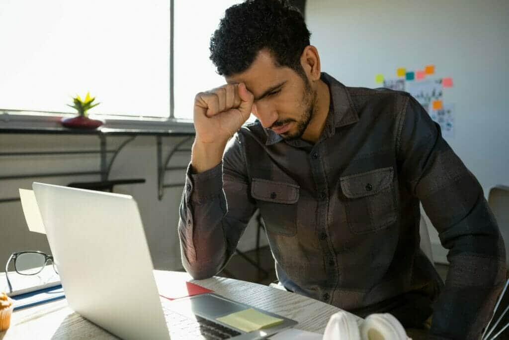 Frustrated businessman sitting at desk