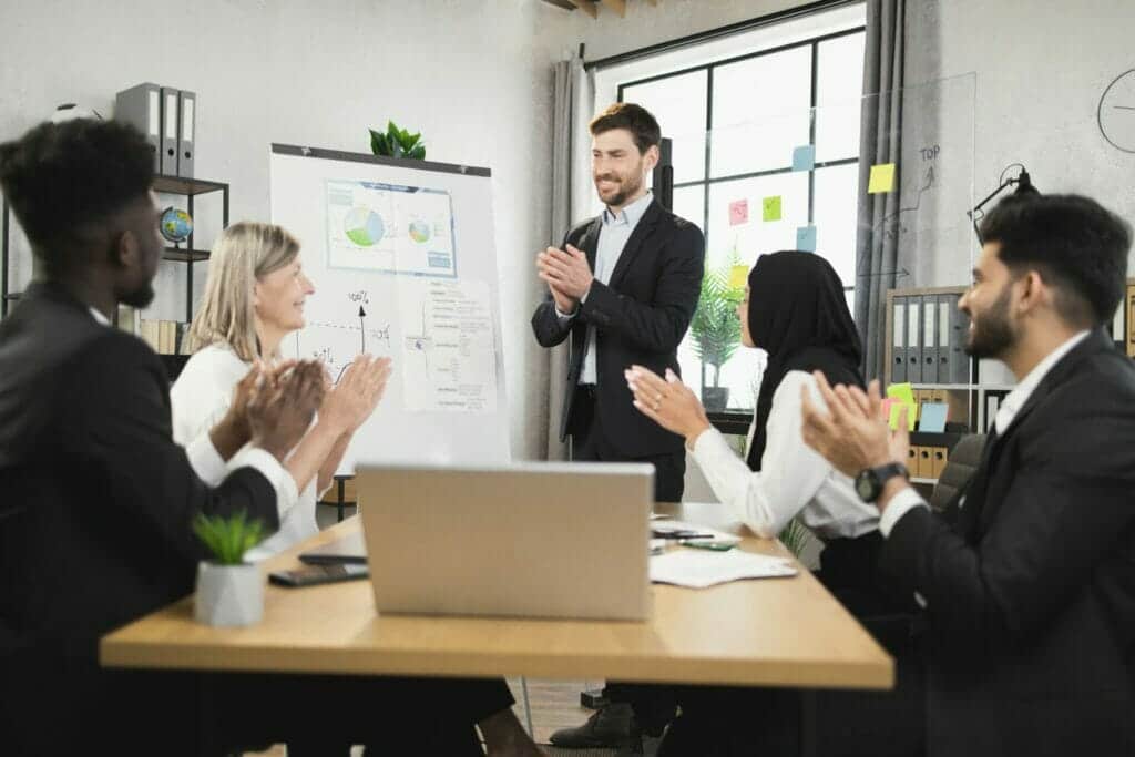 Multicultural business partners applauding during meeting
