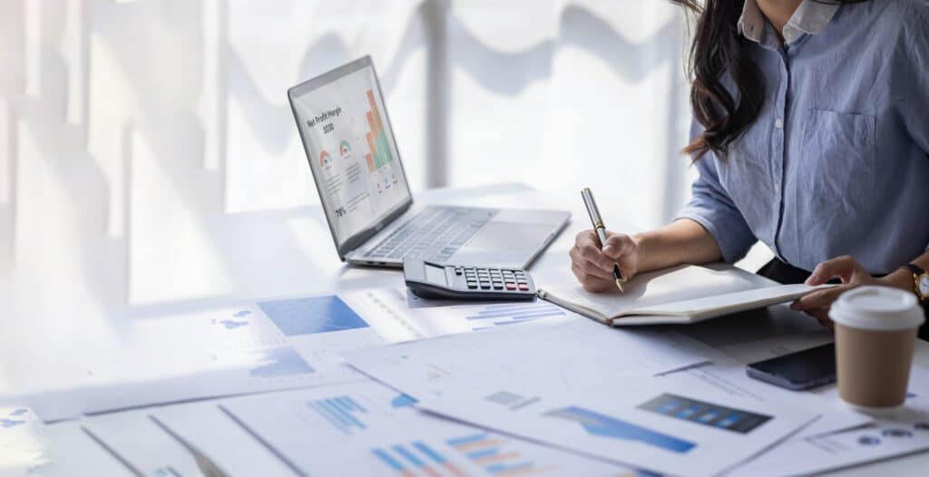 Financial Businesswomen analyze the graph of the company's performance to create profits and growth,
