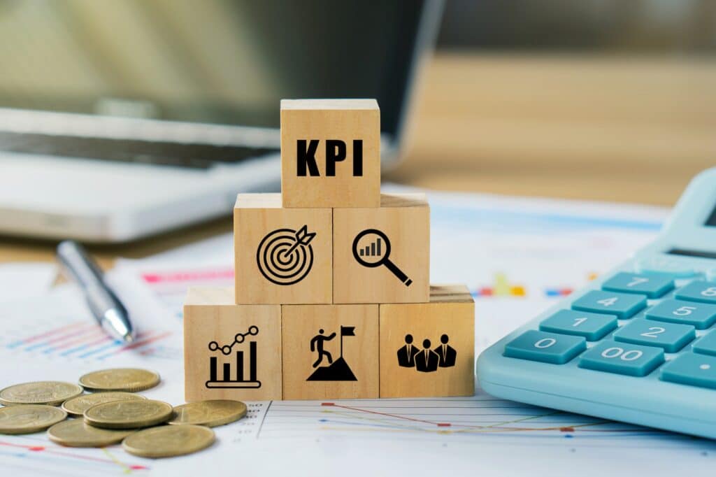 KPI, Key Performance Indicator.KPI icon on wooded cube o a board room table.