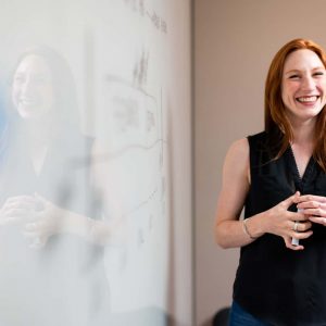 Photo by ThisisEngineering RAEng woman in blue tank top standing beside white wall
